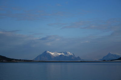 Scenic view of snowcapped mountains by sea against sky