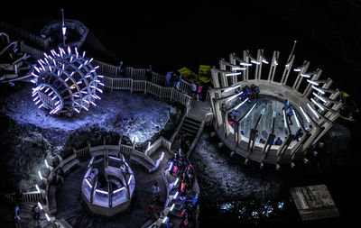 High angle view of illuminated amusement park at night