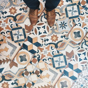 Low section of woman standing on tiled floor