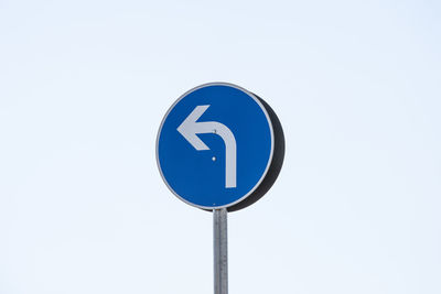 Low angle view of road sign against clear sky