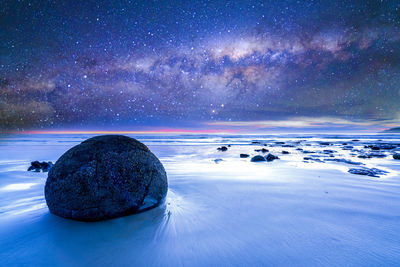 Scenic view of sea against sky at night