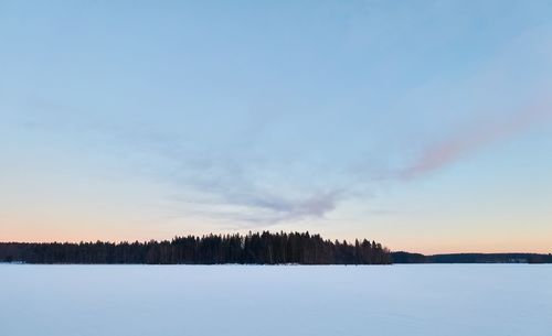 Snow covered landscape against sky