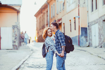 Young couple standing on street in city