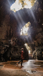 Woman standing in cave