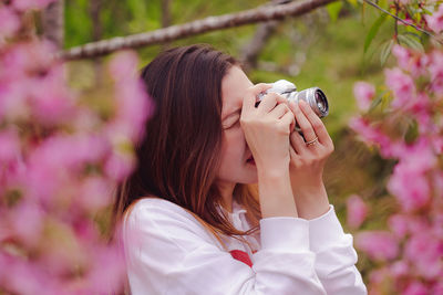 Woman photographing at park