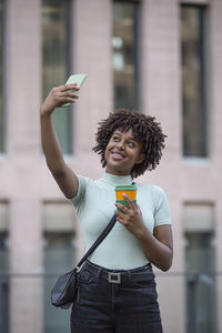 Young man making selfie with mobile phone. young woman outdoors in the city. technology 