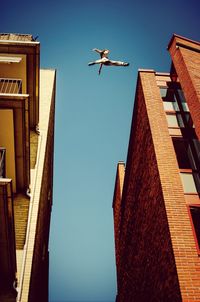 Low angle view of building against clear blue sky