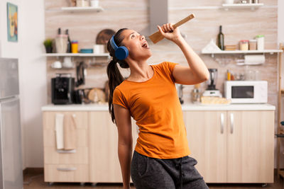 Full length of young woman standing at home