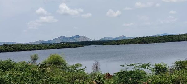 Scenic view of lake and mountains against sky