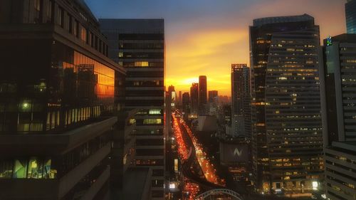 Illuminated modern buildings in city at night