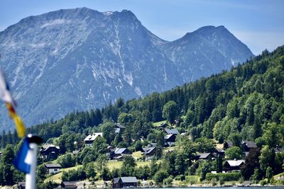 Scenic view of trees and houses against mountains