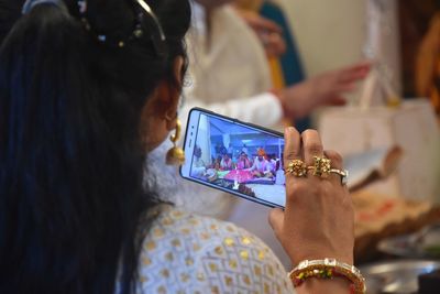 Midsection of woman using mobile phone