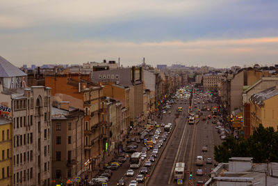 High angle view of city street amidst buildings against sky