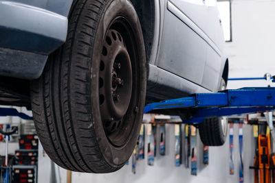 Cropped image of car in auto repair shop