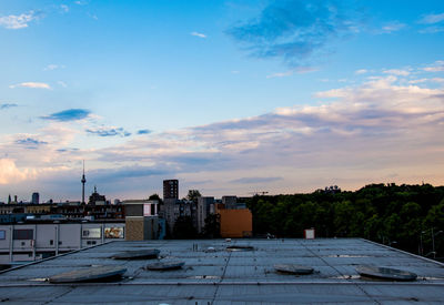 Buildings in city against sky at sunset