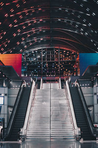 Low angle view of illuminated escalator at subway station
