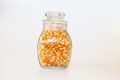 Close-up of glass jar against white background