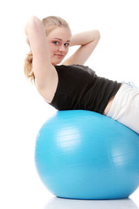 Portrait of young woman with ball in background