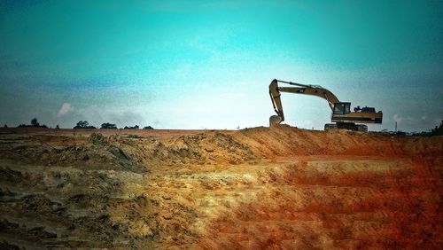 View of machinery on landscape against clear sky