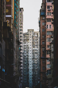 Low angle view of buildings in city against sky