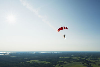 Person paragliding flying in sky