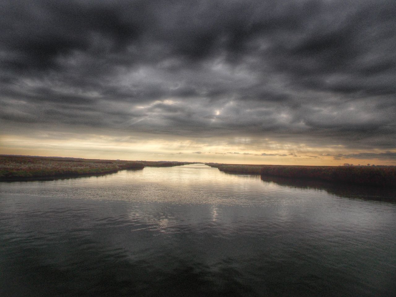 water, tranquil scene, sky, scenics, tranquility, cloud - sky, beauty in nature, cloudy, waterfront, nature, cloud, sea, overcast, reflection, idyllic, lake, rippled, weather, sunset, storm cloud