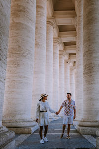 Full length of woman standing at historic building