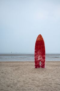 Lifeguard hut on beach against sky