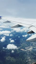 Aerial view of airplane wing against sky