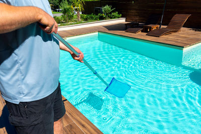 Midsection of man working in pool