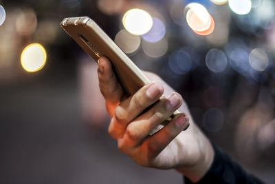 Close-up of woman using mobile phone at night