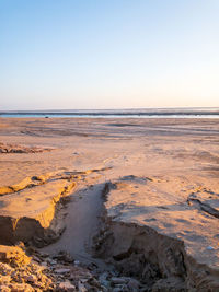 The sun in the desert of kuwait and on a large spot of water after rain.
