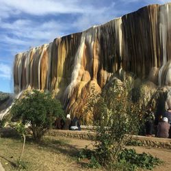 Panoramic view of waterfall against sky