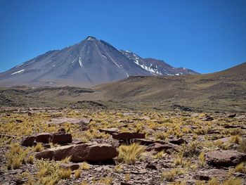 Scenic view of mountains against clear blue sky