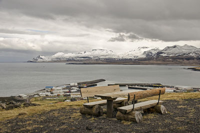 Wooden picknick table in the mountains near olafsvik in iceland with a view of the town and fjord