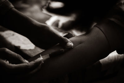 Close-up view of doctor's hands taking a blood sample from a pregnant lady. 