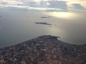 High angle view of buildings by sea against sky