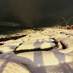 Scenic view of beach against sky during winter