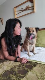 Young woman sitting on sofa at home