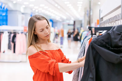 Shopping concept, fashion style and people happy woman in red coat chooses