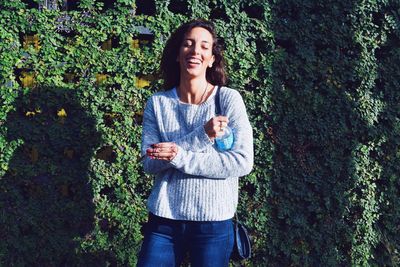 Portrait of young woman standing outdoors