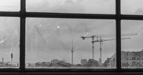 Panoramic view of city buildings seen through glass window