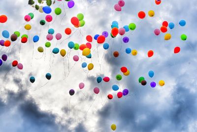 Low angle view of balloons against sky