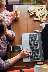 Woman mother working doing her job remotely during video chat call stream online course