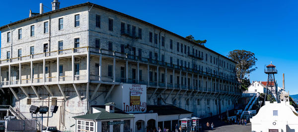 Low angle view of buildings against clear blue sky