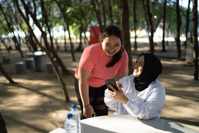 Side view of young woman exercising in park