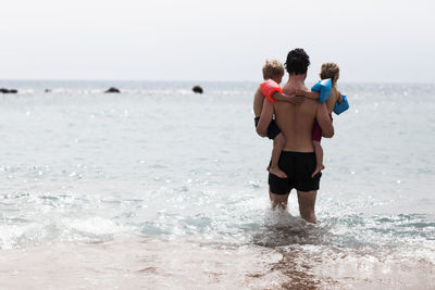 Father with children in sea