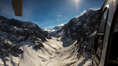 Scenic view of snowcapped mountains against sky during winter