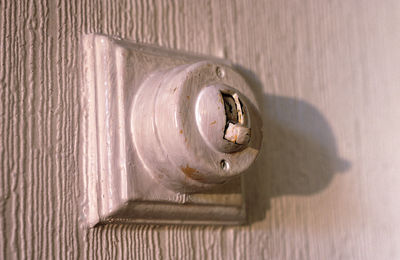 Close-up of old light switch on wall