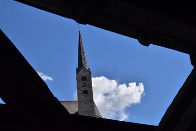 Low angle view of silhouette building against sky